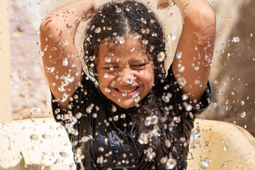 Girl, teenage girl in Brazil playing with water in summer, white background, selective focus. - Powered by Adobe