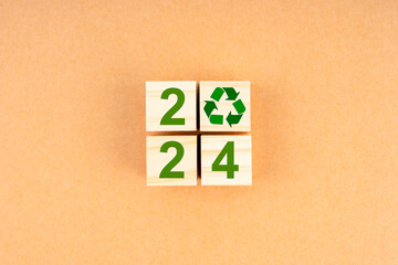 2024 Numbers and recycle symbol on wooden cube.