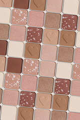 Minimal pattern of eye shadow beige tones swatches, monochrome photo background, eyeshadow with heart imprint, shiny natural shades powder makeup, square shape metal pack, beauty cosmetic texture