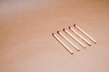New unlit wooden matchsticks orderly aligned on natural brown background
