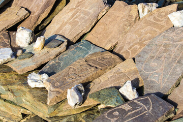 Tibetan mantras on stones, a high-altitude lake in the Himalayas, Ladakh