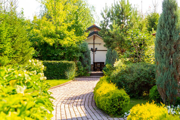 Stone path to the gazebo in the summer garden