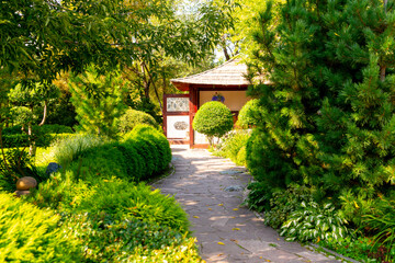 Stone path to the Japanese gazebo in the summer garden