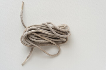 pair of grungy shoe laces bundled together