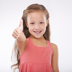 Thumbs up, kid and portrait of girl in studio for winner, achievement or celebrate success on white background. Happy child, emoji or like sign for yes, feedback or thank you for agreement of support