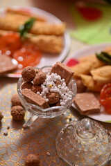 plate with snacks and bowl with indian sweets. Makar Sankranti traditional sweets and snacks. Breakfast tea time. Maharashtra culture