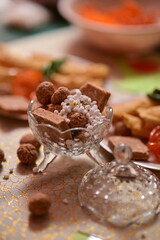 plate with snacks and bowl with indian sweets. Makar Sankranti traditional sweets and snacks. Breakfast tea time. Maharashtra culture