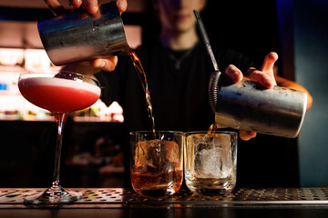 Bartender making alcohol cocktail in a bar, close-Up.