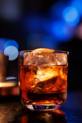 A glass of whiskey on the bar counter.