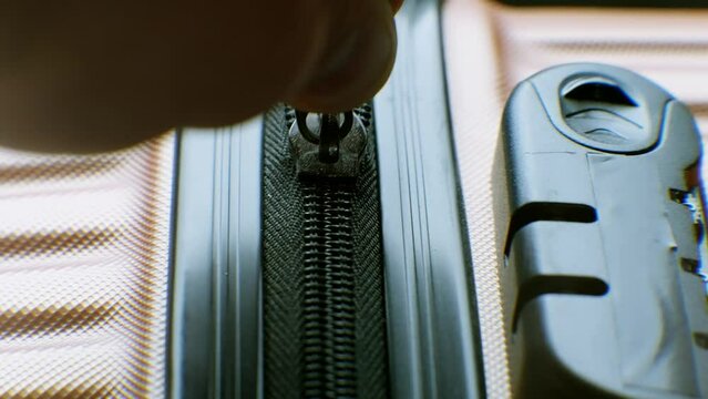 Suitcase being secured with zipper . Business trip zipping luggage	