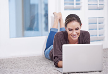 Woman, remote work and laptop to relax on floor, update blog post and digital news on social media at home. Happy freelancer, computer or download subscription, online shopping or streaming on ground