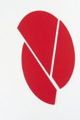 deconstructed oval or three segments of a solid red paper shape on white