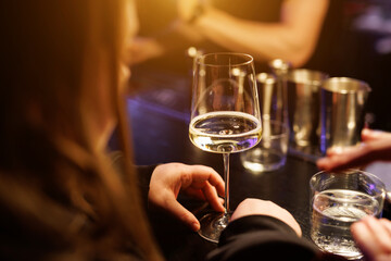 Woman with a glass of white wine in a bar