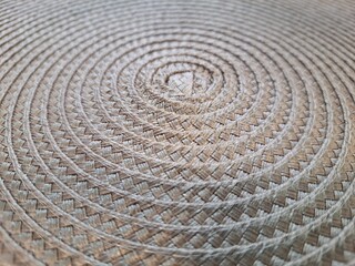 Fototapeta na wymiar Closeup of a woven straw background. Upper view
