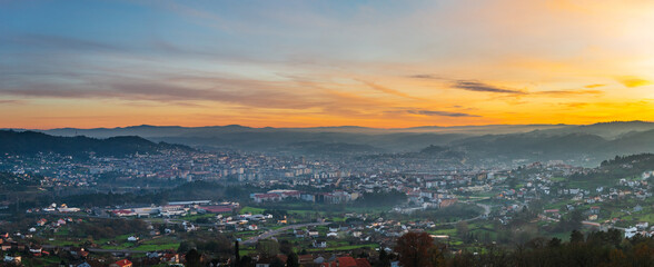 Panorama view of the skyline of the Galician city of Ourense at dusk as seen from the outskirts. - obrazy, fototapety, plakaty