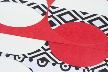machine-cut stencils with oval cutouts and red solids on white