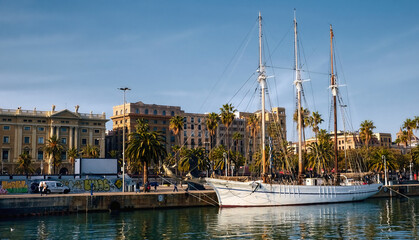 Elegante white yacht moored in port of Barcelona. Coastline, sunny day. Sailing - obrazy, fototapety, plakaty