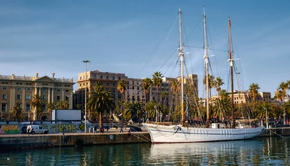 Fotobehang Elegante white yacht moored in port of Barcelona. Coastline, sunny day. Sailing © Terri_Crozier 