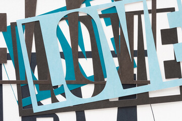 layered machine-cut stencils with the word 