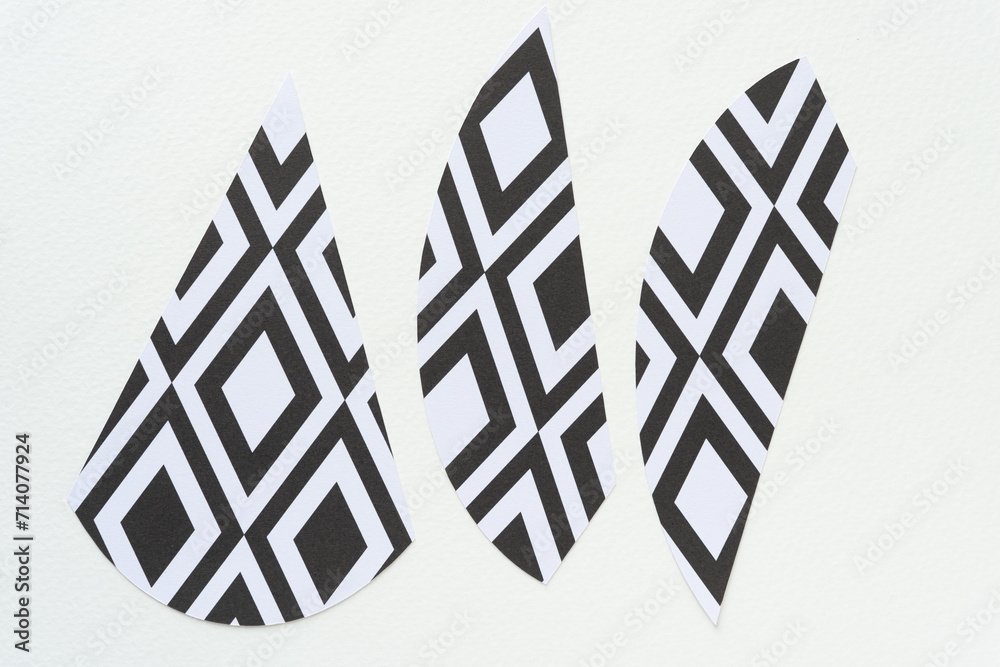 Poster three machine-cut paper shape with black and white diamantine patterns