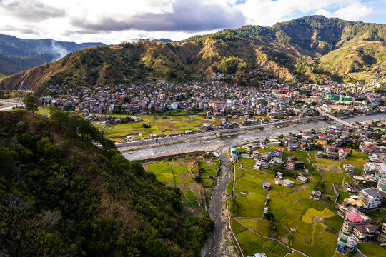 Aerial of the town of Bontoc, the capital of the landlocked province of Mountain Province, in the Cordillera Region of the Philippines. A valley town with terraced rice fields and residential areas.
