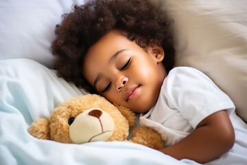 Obraz na płótnie Canvas Toddler boy in shirt sleeps sweetly in company of best friend teddy bear seeing pleasant dreams