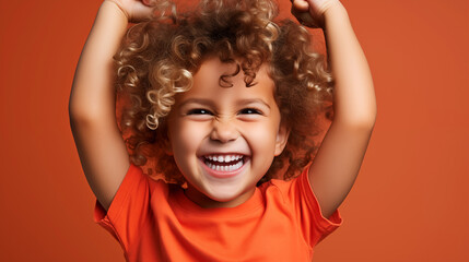 The little boy in orange laughs. - obrazy, fototapety, plakaty