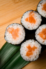 Close up sushi delights on wooden platter. flavorful experience
