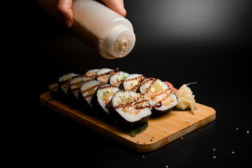 Hand seasoning sushi set with sesame seeds
