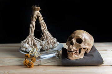 skulls , decorative dried herbs and a skeletal head, perfect for Halloween or medical-themed design
