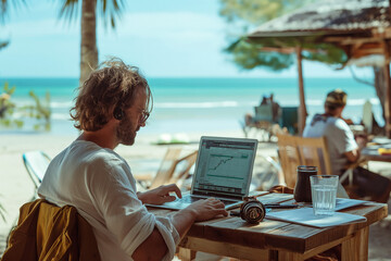 Man Analyzing Data on Laptop at Beachside Café