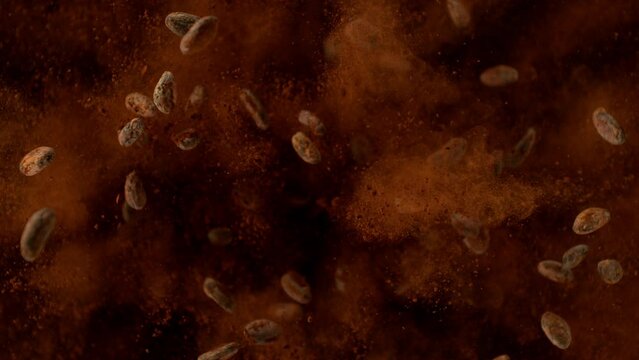 Super slow motion of pieces of chocolate chunks and raw cocoa beans exploding. Top view. Filmed on high speed cinematic camera at 1000 fps.