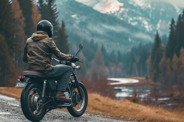 motorcycle and man sitting on it,looking back - obrazy, fototapety, plakaty