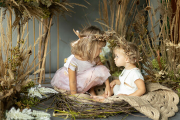 little children dressed as elves in floral decorations