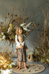 little children dressed as elves in floral decorations