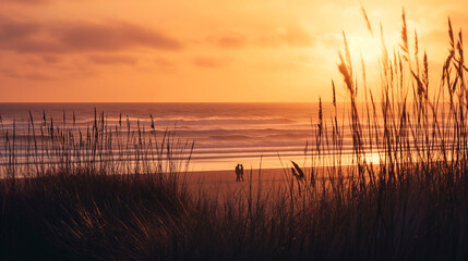 A serene seaside view at golden hour and the silhouette of a couple on the beach. Copy Space.