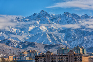 Picturesque view of the peaks of the Trans-Ili Alatau and part of the Kazakh city of Almaty on a...