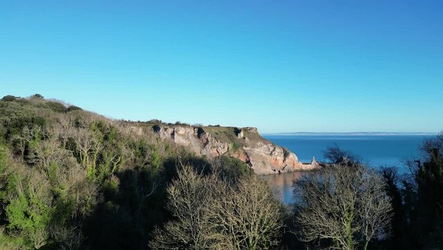 Babbacombe, Torbay, South Devon, England: DRONE VIEWS: Anstey's Cove is "revealed" from behind trees. The Cove was formerly used by smugglers and frequented by crime writer, Agatha Christie (Clip 1).