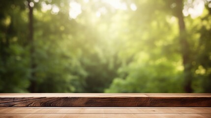 Wooden table top with blurred green forest blur background.