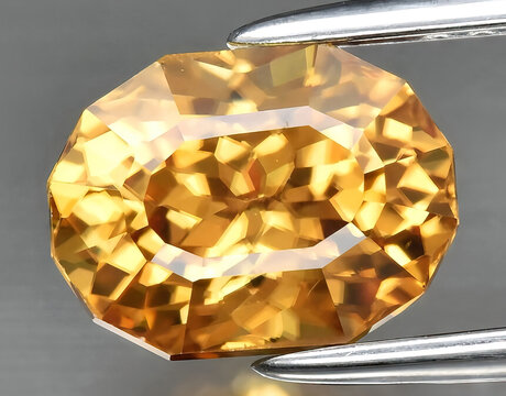 natural yellow zircon gem on the background