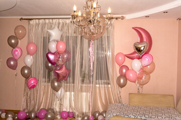 The room is decorated with various balloons
