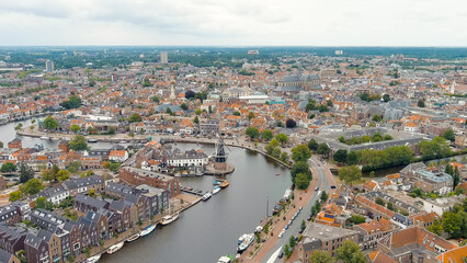 Fototapeta na wymiar Haarlem, Netherlands. Windmill De Adriaan (1779). Windmill from the 18th century. Panoramic view of Haarlem city center. Cloudy weather during the day. Summer, Aerial View