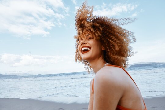 Smiling Woman with Backpack Enjoying Happy Vacation on the Beach