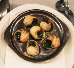 Traditional French food, snails in garlic sauce. Delicacy in Paris.