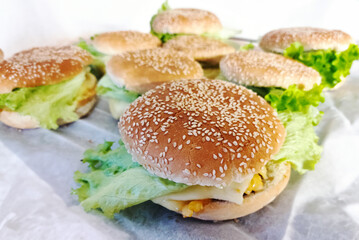 Home cooked burgers, cheeseburger and hamburger on the table.