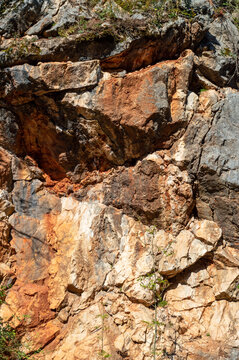 Orange destroyed stone cliff.