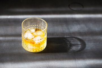 Glass of whiskey on dark background. Close up