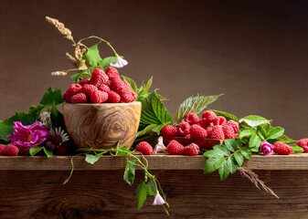 Fresh raspberries in wooden bowl.