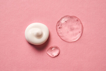 Gel, serum and a cream on a pink background.