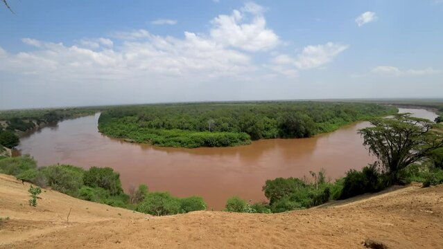 Omo River, flowing through Ethiopia's Omo Valley, is the lifeblood of the region. Its waters sustain communities along its banks, providing vital resources for agriculture and daily life